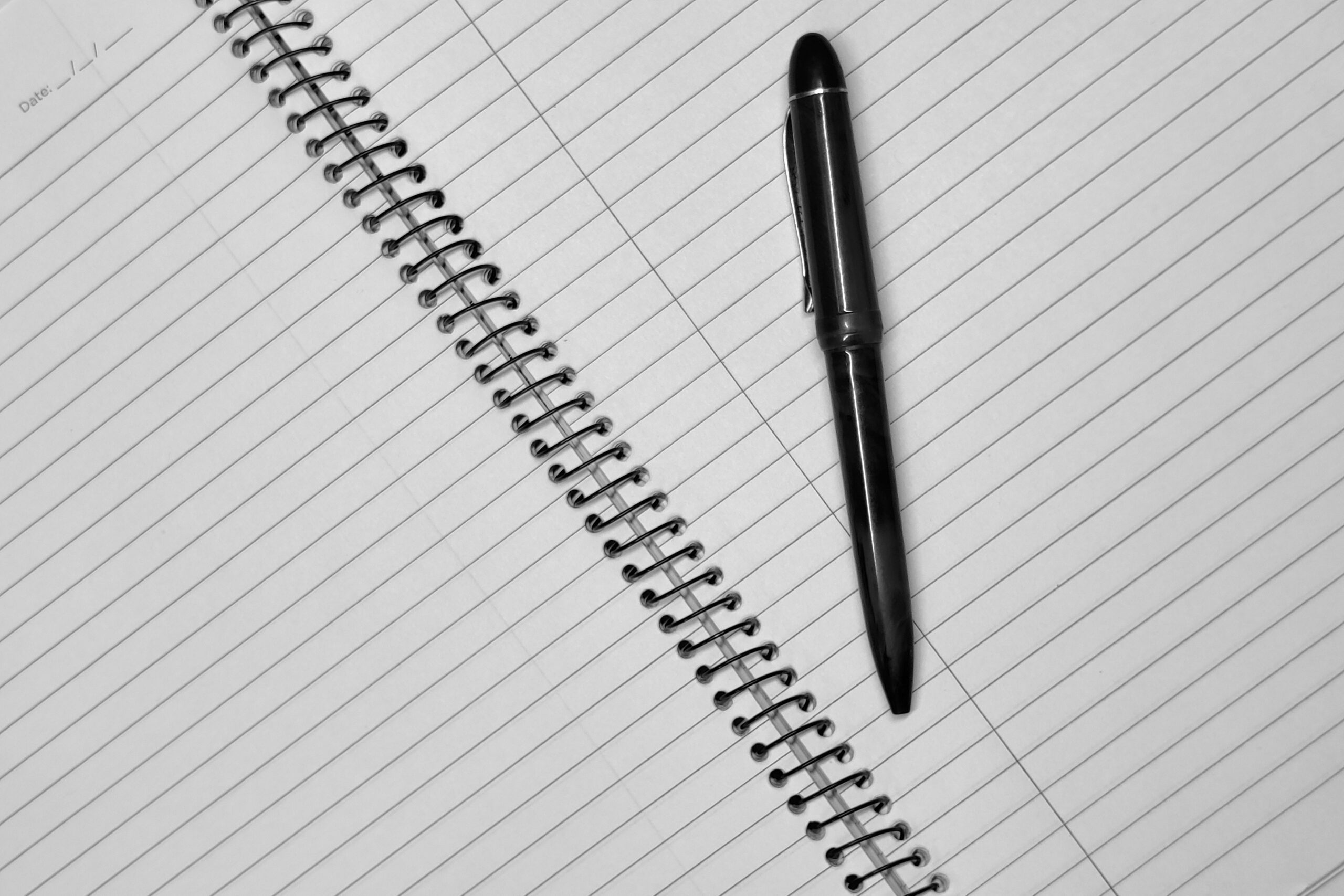 black Pen on Spiral Notebook